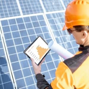 Examining production of solar power plant with digital tablet
