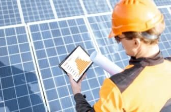Examining production of solar power plant with digital tablet